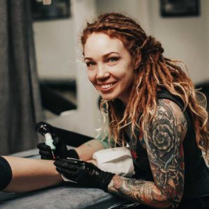 Tattoo Artist Smiling About Tattoo Insurance