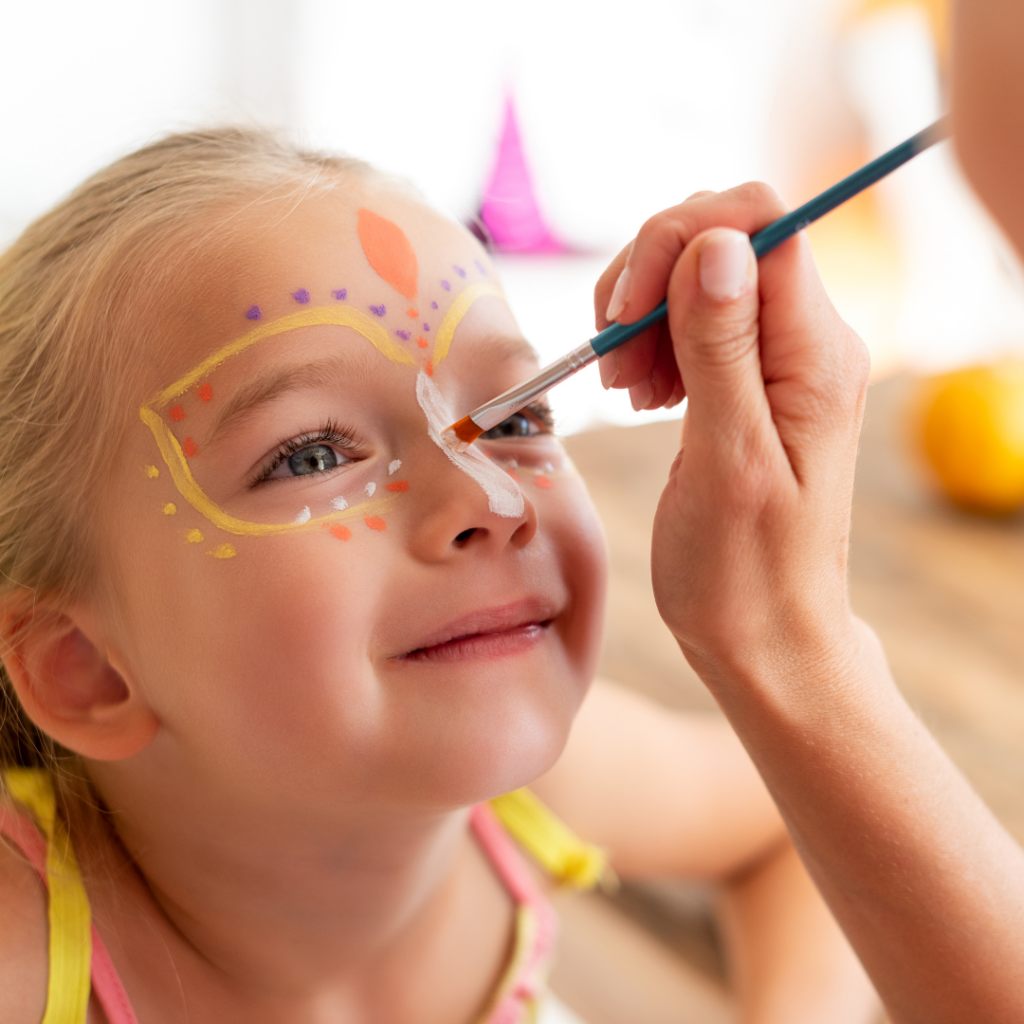a little getting their face painted at a party