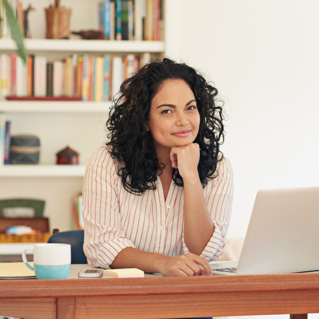 a health and wellness coach at a desk with a laptop