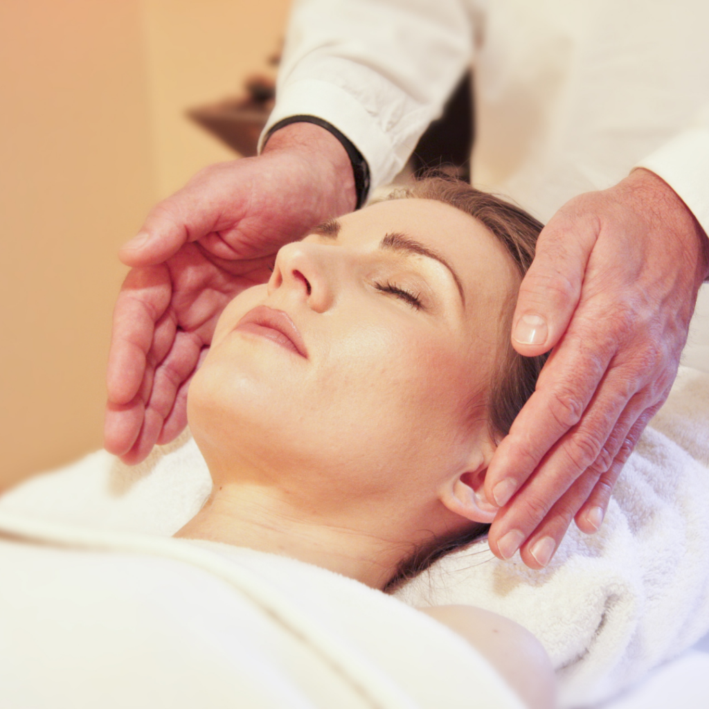 a woman getting a reiki treatment in a spa