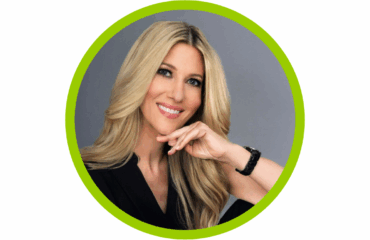 Amy-Salman headshot from the The-Wellness-Map with her hand on her chin smiling