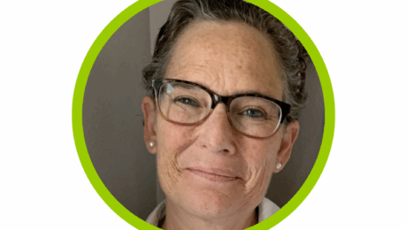 Ann Maynard Payne from Tampa Bay Postpartum Doula headshot, smiling with brown glasses and pearl earrings