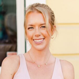 Laura Chandler headshot, in pink tank, smiling