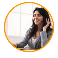 Woman who is smiling at a computer wearing a headset